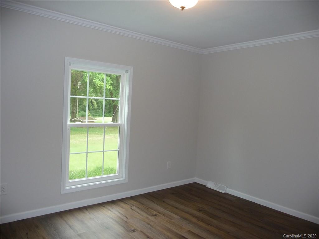 4222 Richardson Road Monroe, NC 28112 - Photo 11 of 21 an empty room with wooden floor and windows
