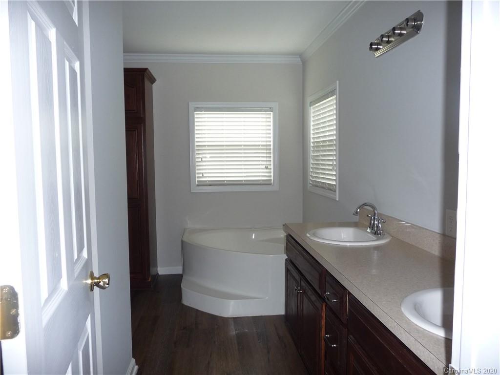 4222 Richardson Road Monroe, NC 28112 - Photo 18 of 21 a bathroom with a double vanity sink a mirror and a bathtub