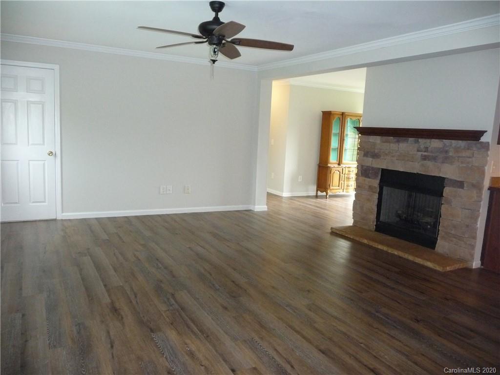 4222 Richardson Road Monroe, NC 28112 - Photo 3 of 21 a view of an empty room with wooden floor fireplace and a window