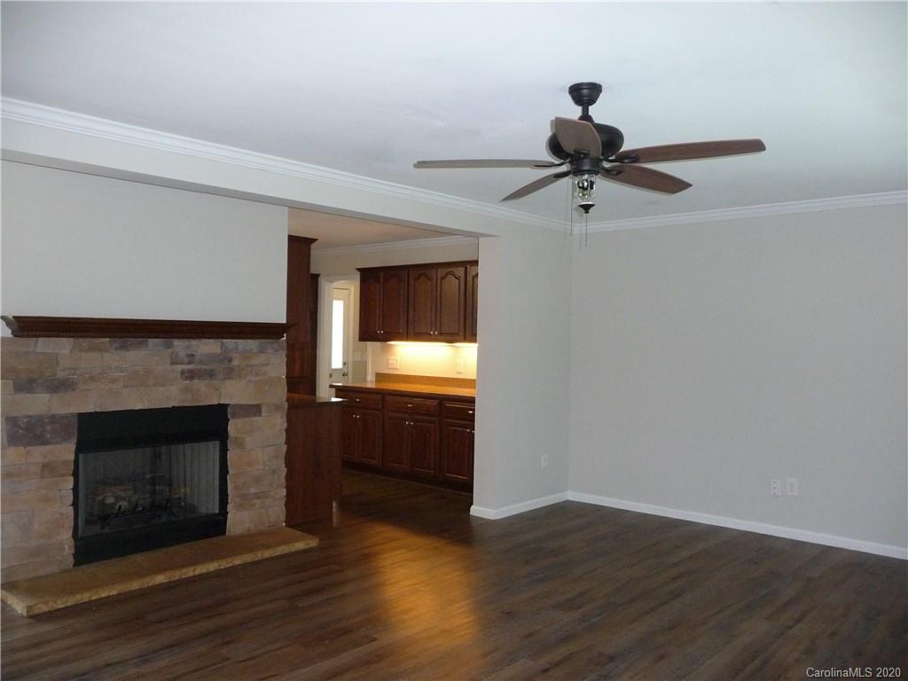 4222 Richardson Road Monroe, NC 28112 - Photo 4 of 21 a view of a livingroom with a fireplace and wooden floor