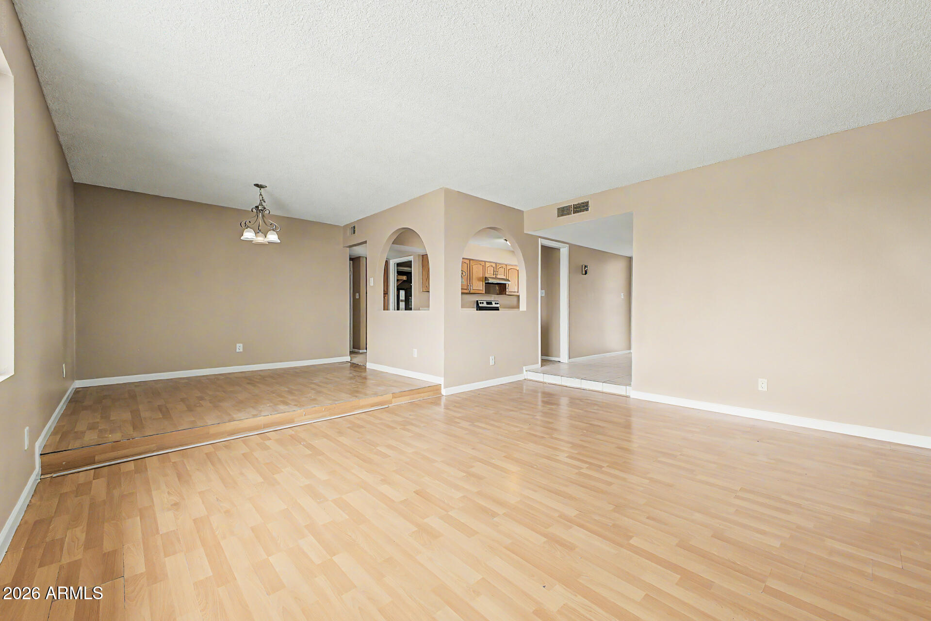 4007 West Mountain View Road Phoenix, AZ 85051 - Photo 8 of 31 a view of an empty room with wooden floor