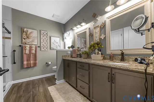 a bathroom with a toilet sink and shower