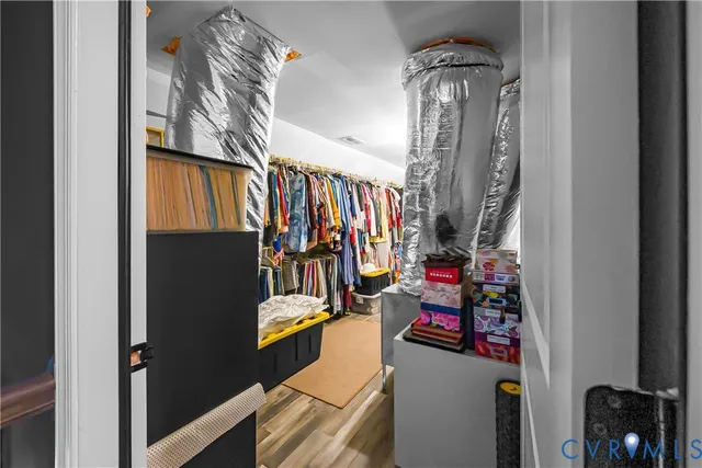 a living room with furniture a flat screen tv and a table