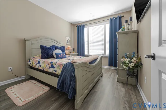 a bedroom with a bed and a potted plant