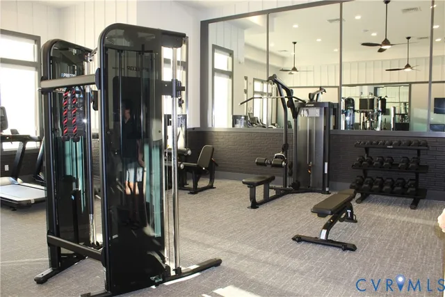 a view of a white house with a big yard and large trees