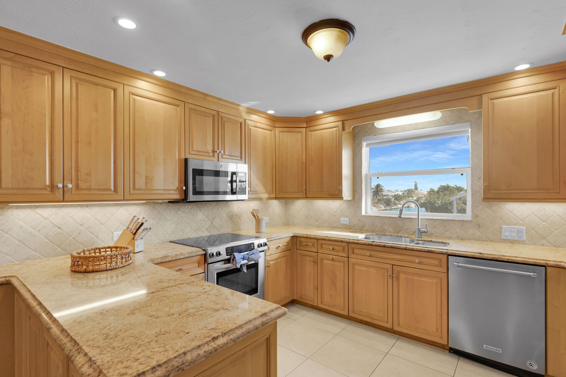 580-590 10th Street Key Colony Beach, FL 33051 - Photo 15 of 75 a kitchen with a sink a stove and cabinets