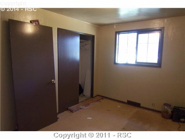 15190 Davis Road Peyton, CO 80831 - Photo 10 of 16 Bedroom 3 is in the remodeling process with no current carpet or flooring.
