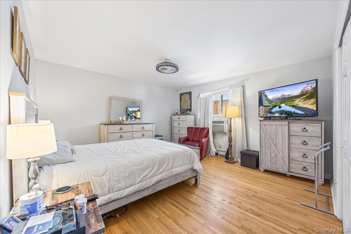 782 Tuckahoe Road, Unit 3C Yonkers, NY 10710 - Photo 13 of 19 a bedroom with a bed and a flat screen tv