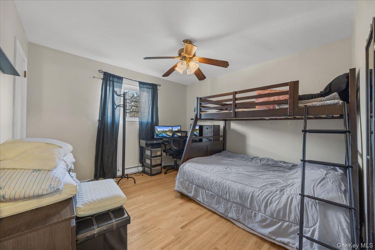 782 Tuckahoe Road, Unit 3C Yonkers, NY 10710 - Photo 15 of 19 a bedroom with a bed and a chandelier