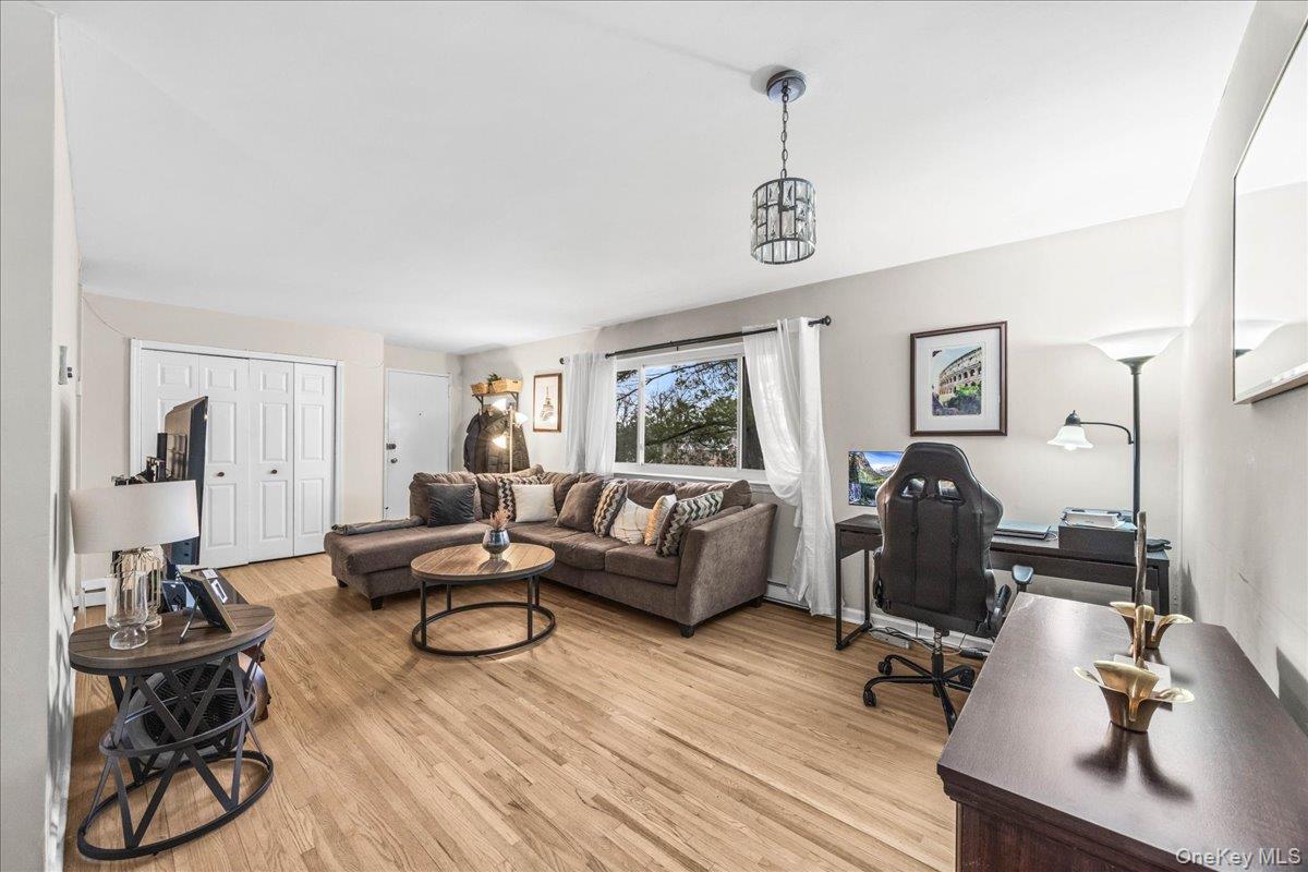 782 Tuckahoe Road, Unit 3C Yonkers, NY 10710 - Photo 5 of 19 a living room with furniture a flat screen tv and gym equipment