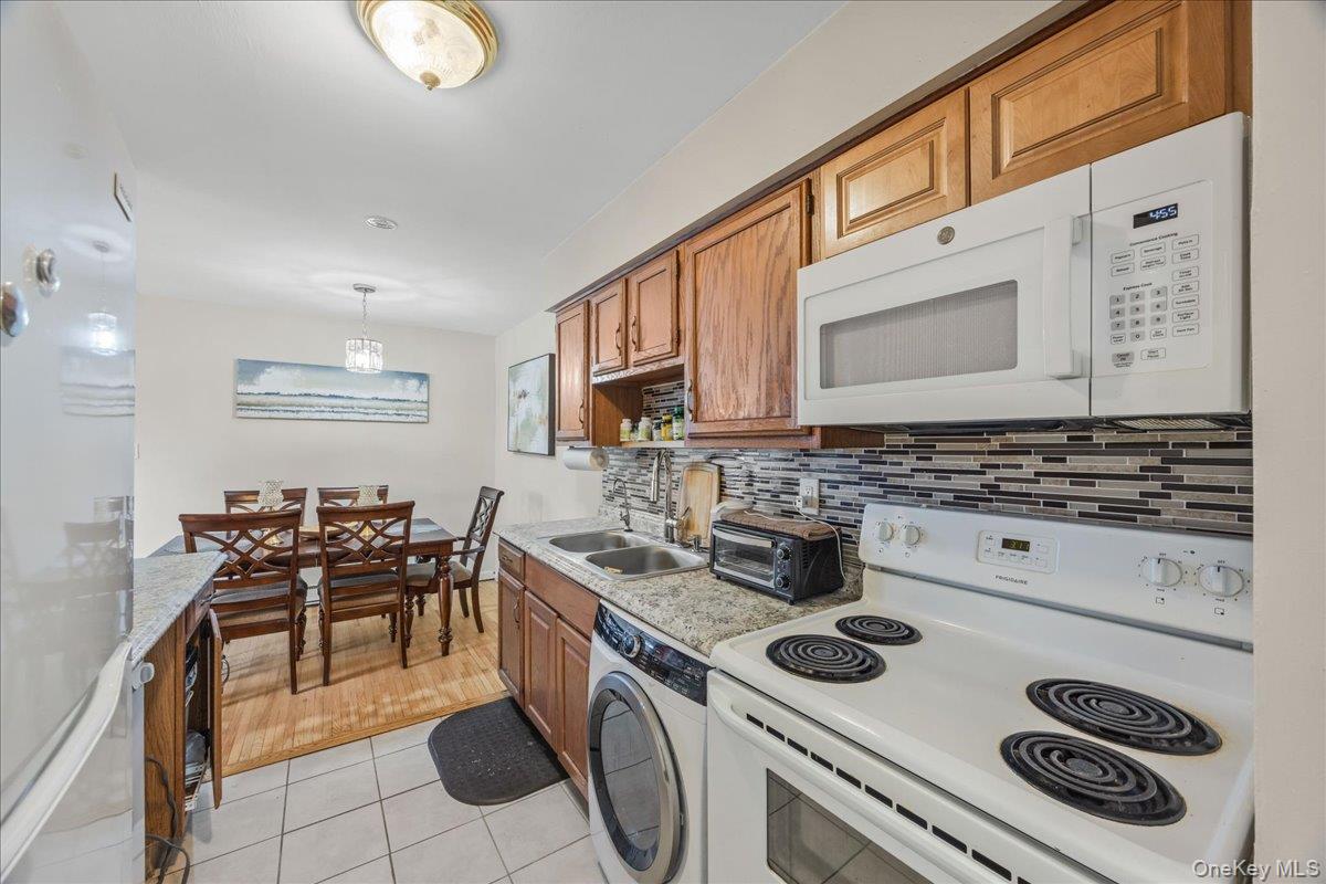 782 Tuckahoe Road, Unit 3C Yonkers, NY 10710 - Photo 9 of 19 a kitchen with a stove and white cabinets