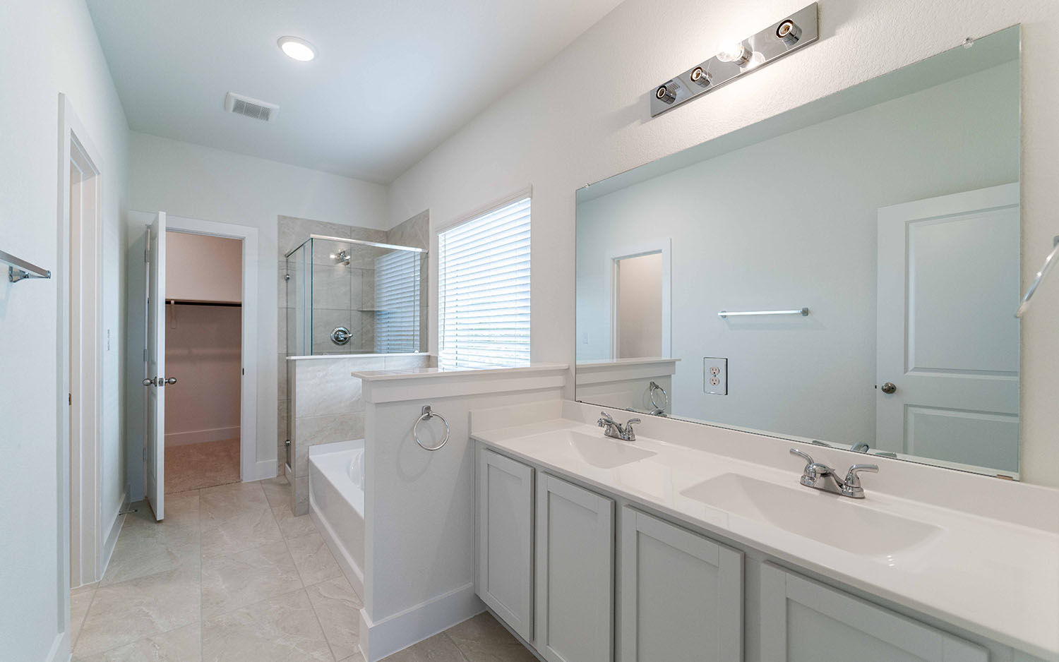 104 Old Silver Drive Jarrell, TX 76537 - Photo 11 of 19 Bathroom with a stall shower, double vanity, a bath, a walk in closet, and tile patterned flooring