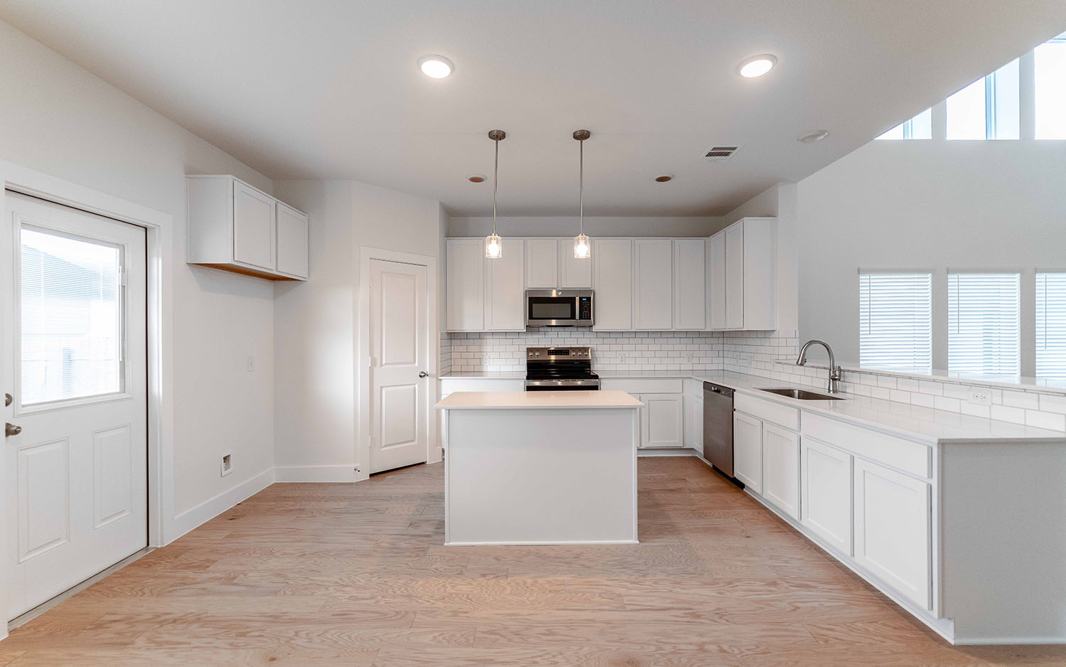 104 Old Silver Drive Jarrell, TX 76537 - Photo 8 of 19 Kitchen with healthy amount of natural light, decorative backsplash, appliances with stainless steel finishes, and recessed lighting