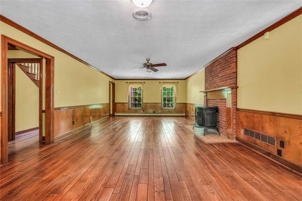 314 Winding Stream Trail Southwest Conyers, GA 30094 - Photo 20 of 59 a view of a living room hardwood floor to ceiling window and wooden floor