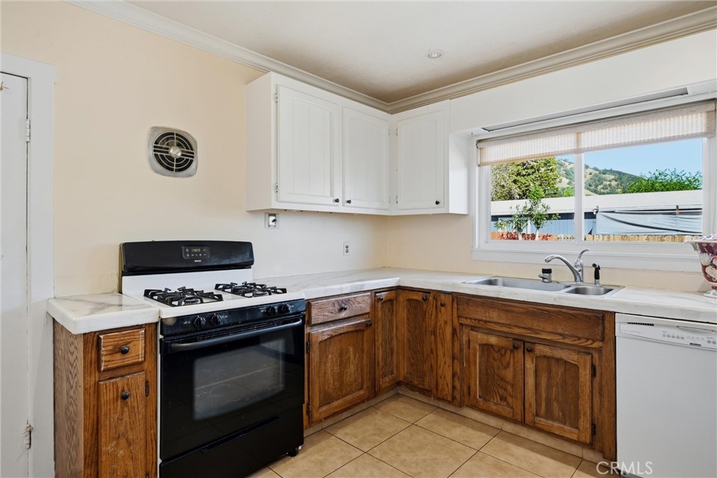 3440 Beach Nice, CA 95464 - Photo 14 of 27 a kitchen with a sink stove top oven and cabinets
