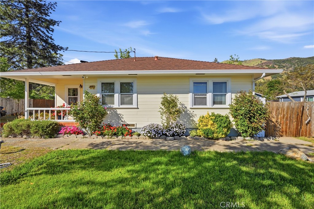 3440 Beach Nice, CA 95464 - Photo 19 of 27 a front view of a house with a yard