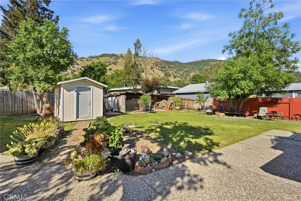 3440 Beach Nice, CA 95464 - Photo 20 of 27 a front view of a house with a garden