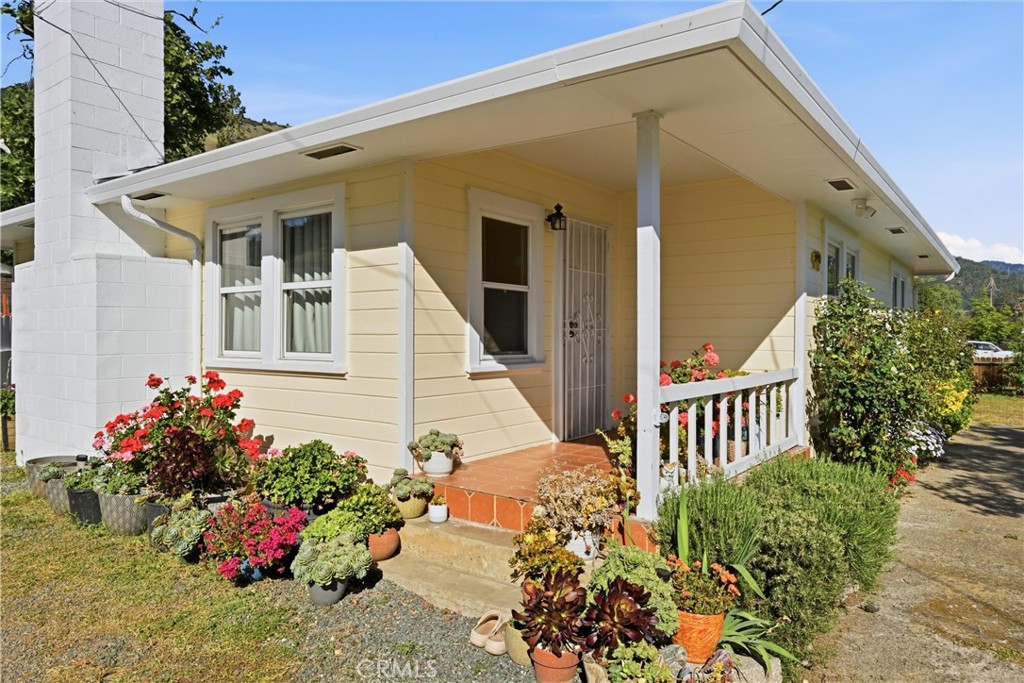 3440 Beach Nice, CA 95464 - Photo 2 of 27 a flower garden is sitting in front of a house