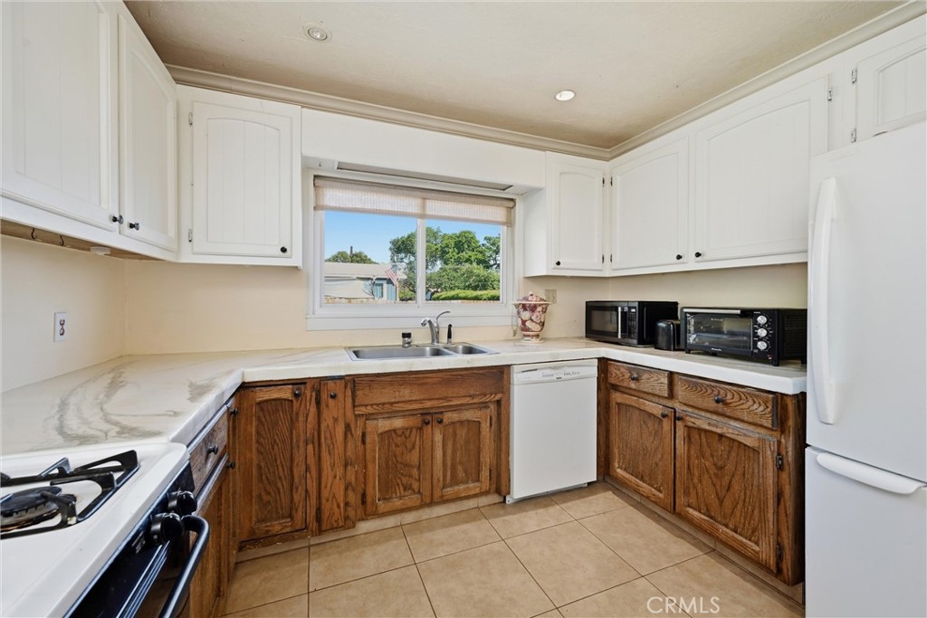 3440 Beach Nice, CA 95464 - Photo 9 of 27 a kitchen with a sink stove top oven and cabinets