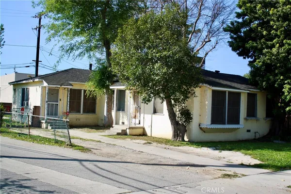 a front view of a house with garden and plants