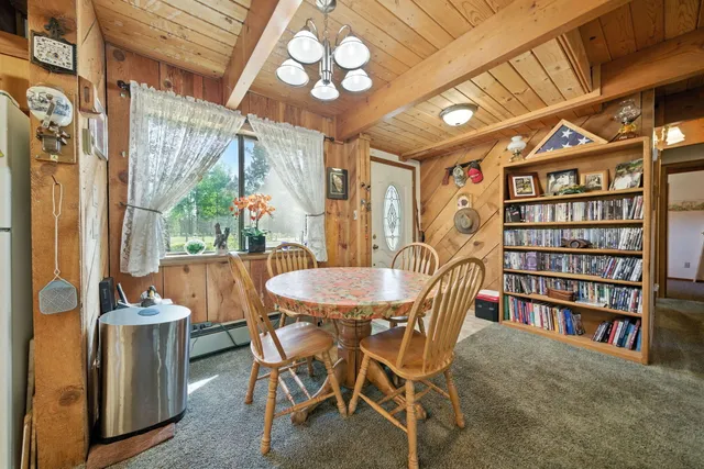 a dining room with furniture and a book shelf