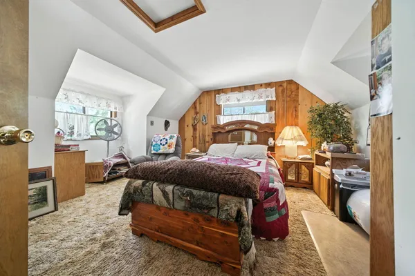 a bed sitting in a bedroom next to a window