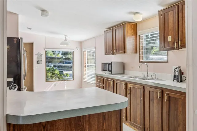 a kitchen with stainless steel appliances granite countertop a sink a stove and a refrigerator