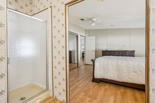 a view of an empty room and wooden floor