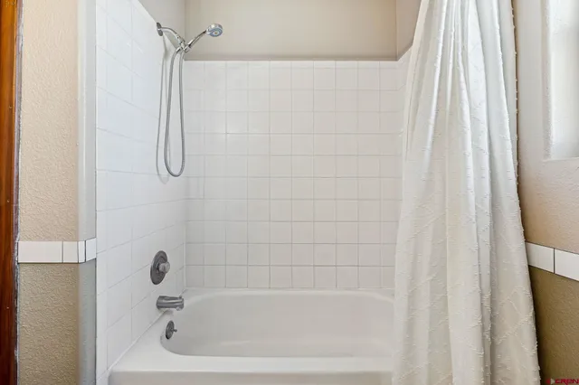 a close up of a bathtub curtain