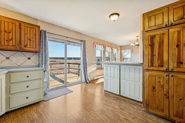 a view of a bedroom with cabinet wooden floor and door