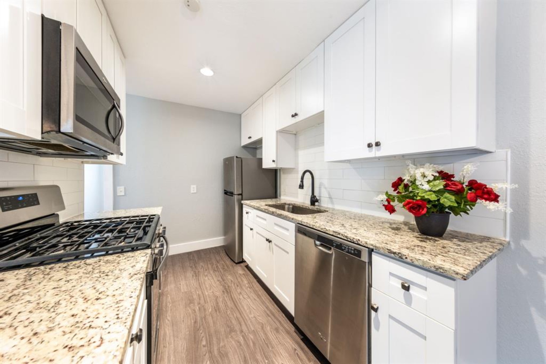 1423 Braes Ridge Drive, Unit B Austin, TX 78723 - Photo 8 of 13 a kitchen with granite countertop a sink stove and cabinets