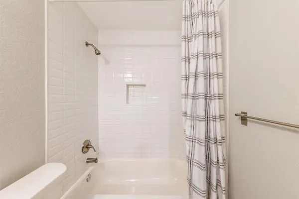 a bathroom with a bathtub and shower