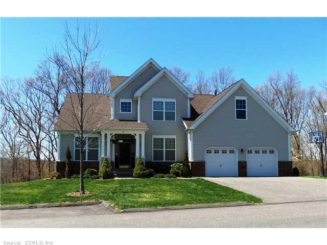 20 Independence Circle Middlebury, CT 06762 - Photo 1 of 1 a front view of a house with a yard and garage