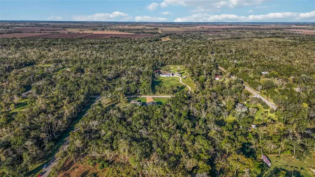a view of a yard with wooden fence