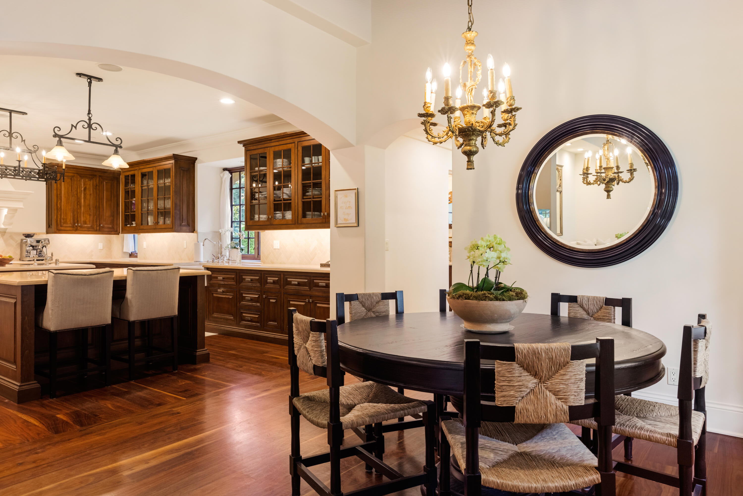 2035 Creekside Road Montecito, CA 93108 - Photo 24 of 60 a dining room with wooden floor a chandelier a wooden table and chairs