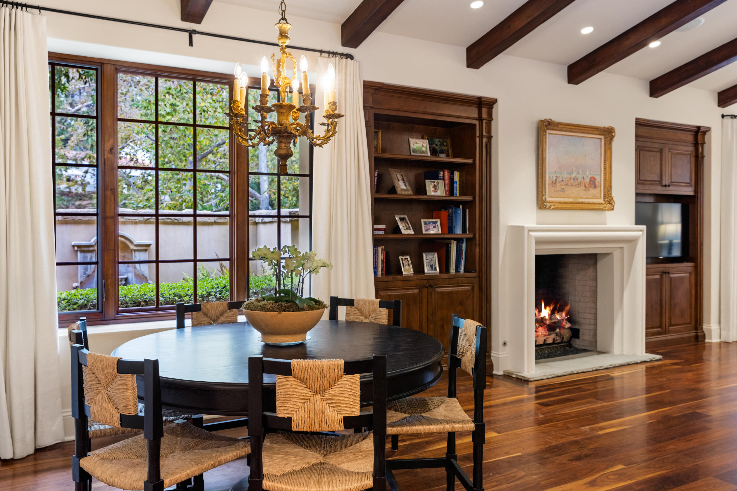 2035 Creekside Road Montecito, CA 93108 - Photo 26 of 60 a dining room with furniture a fireplace and wooden floor
