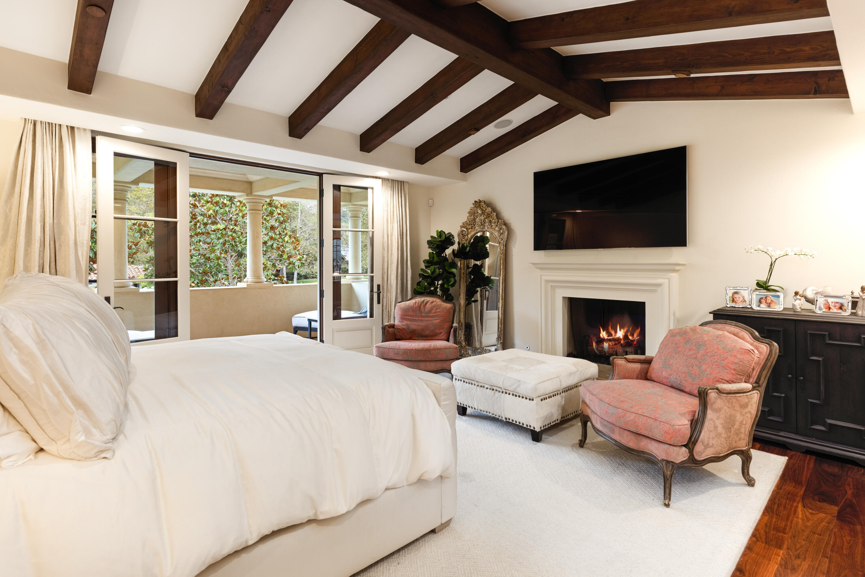 2035 Creekside Road Montecito, CA 93108 - Photo 35 of 60 a large bedroom with furniture fireplace and a flat screen tv