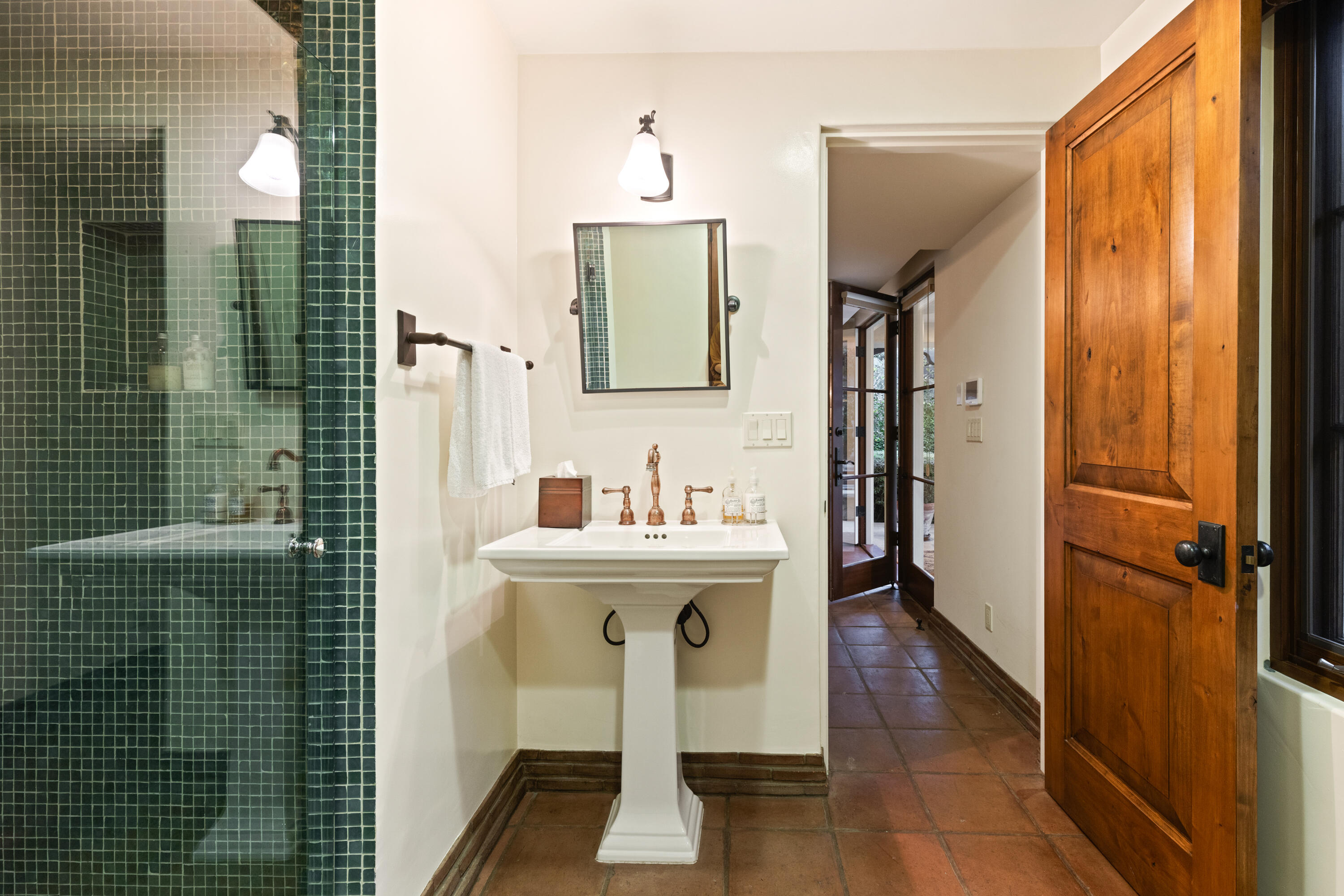 2035 Creekside Road Montecito, CA 93108 - Photo 52 of 60 a bathroom with a sink a mirror and shower