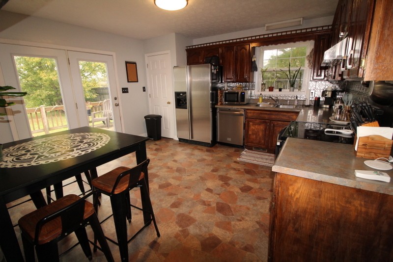 599 Lear Road Portland, TN 37148 - Photo 8 of 25 a kitchen with a table chairs refrigerator and cabinets
