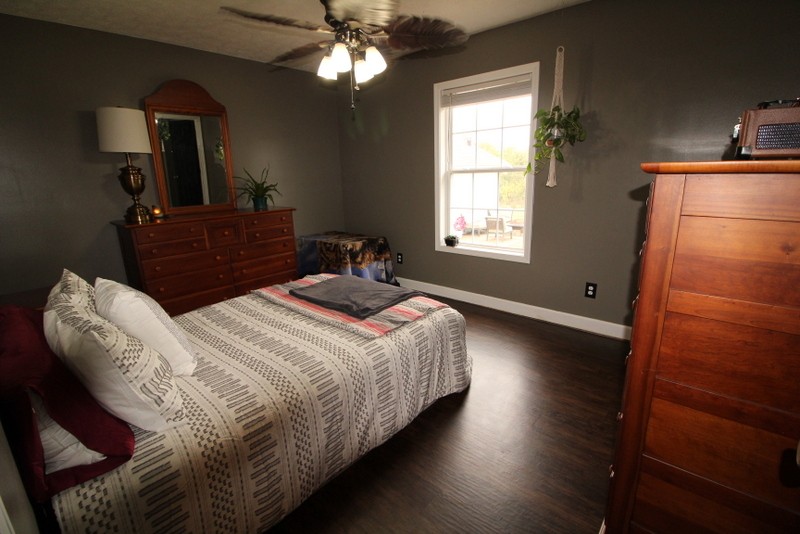 599 Lear Road Portland, TN 37148 - Photo 10 of 25 a bedroom with a bed and a chandelier