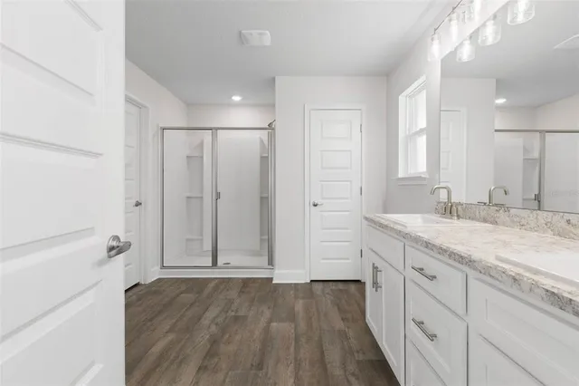 a bathroom with a granite countertop sink mirror and