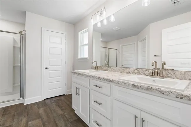a bathroom with a granite countertop sink mirror and