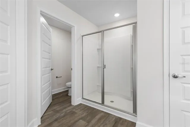 a bathroom with a glass shower door