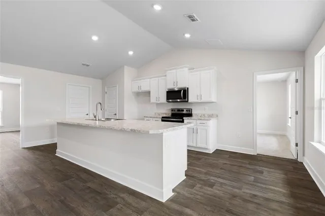 a kitchen with cabinets a sink and appliances