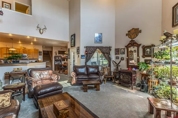 a living room with furniture a rug and a large window