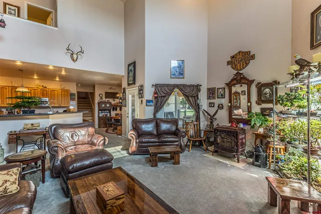 a living room with furniture a rug and a large window