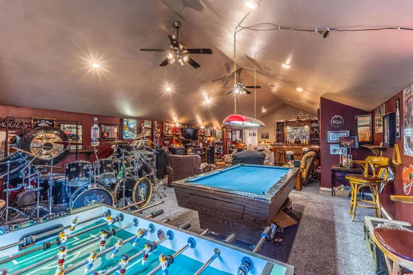 a living room with lots of furniture and clutter