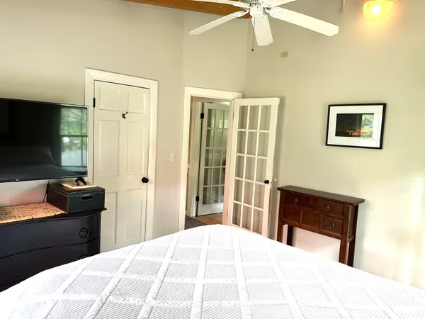 a bedroom with a bed and a mirror