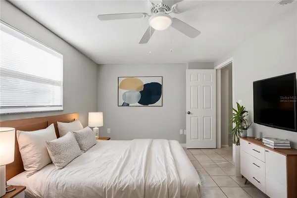 a bedroom with a bed and a flat screen tv