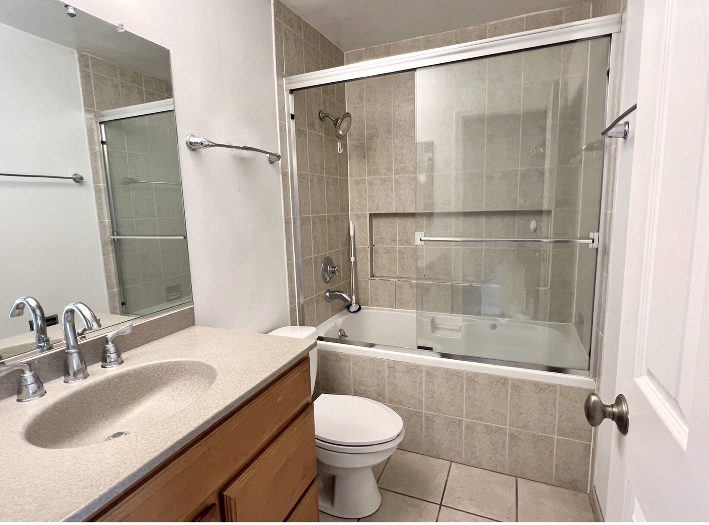 2225 West Nichols Road, Unit D Arlington Heights, IL 60004 - Photo 12 of 12 a bathroom with a sink toilet and shower